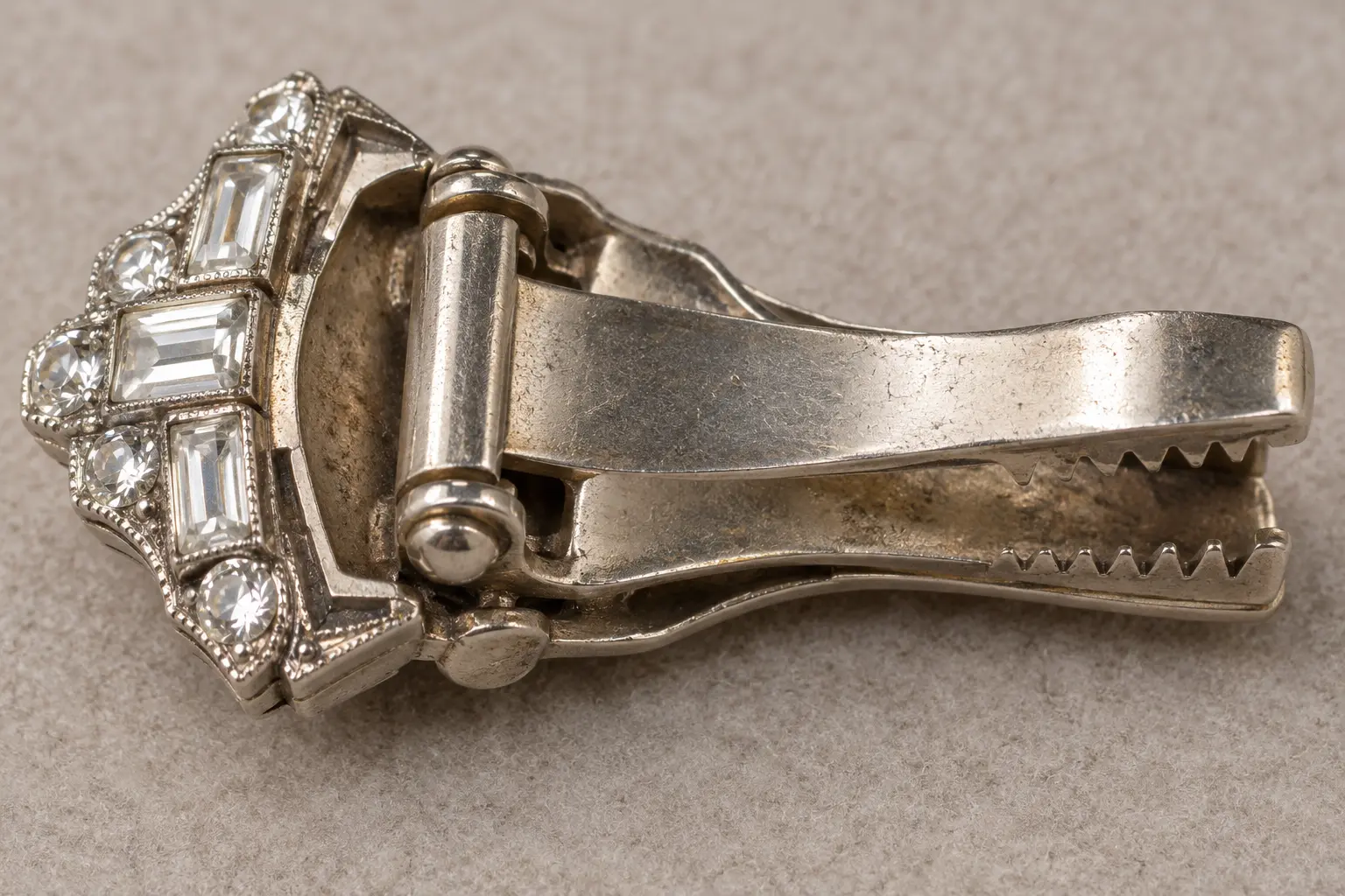 Back view of a period-inspired dress clip showing its hinged fastening